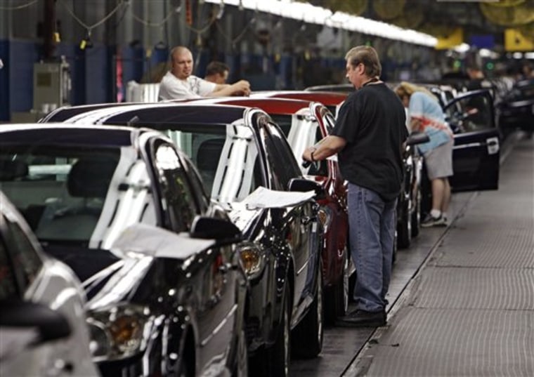 Workers at General Motors' Lordstown Assembly plant in Lordstown, Ohio put the final touches on 2011 Chevrolet Cobalts. GM says its July sales rebounded slightly from June.